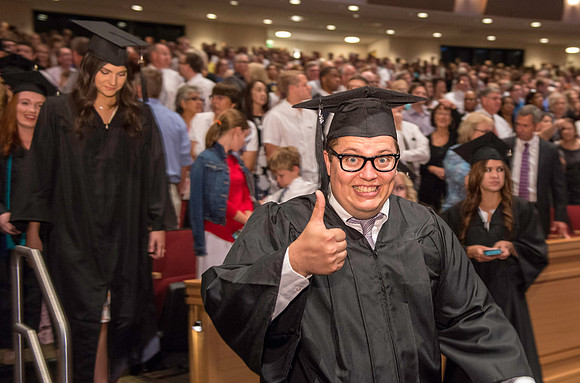Graduates gather for BYU-Idaho commencement. Erik Hill Graduates march in during the processional.
