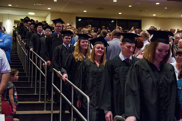 Graduates walking into the BYU-Idaho Center for the Processional march.