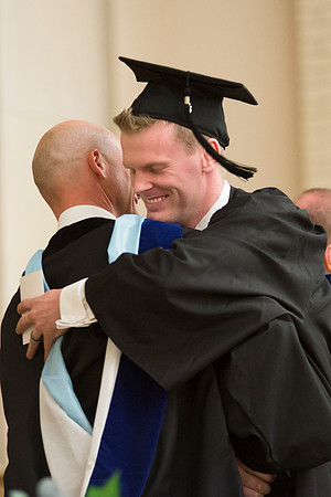Graduate hugs Dean Eric D. Karl at the College of Physical Sciences and Engineering Convocation.