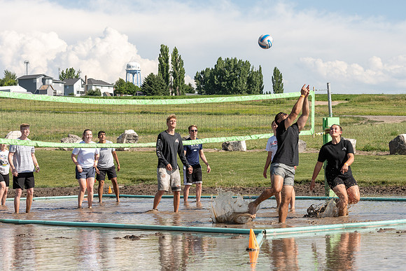 Students gather by the upper fields on the BYU-Idaho Campus to play recreation games, slip 'n' slide, mud volleyball, and try the ropes course.