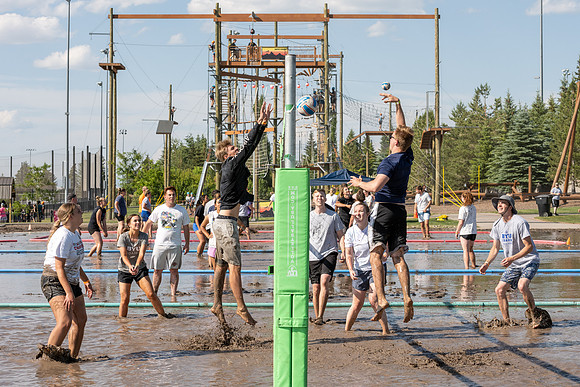 Students gather by the upper fields on the BYU-Idaho Campus to play recreation games, slip 'n' slide, mud volleyball, and try the ropes course.
