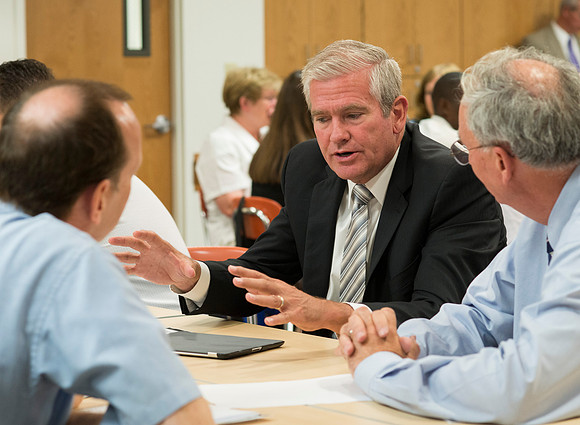 Faculty gather in the Hinckley Building at a Faculty Conference to share and learn from each other at the beginning of the 2013 Fall semester.