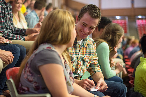 Students gather in the Hart auditorium for a date night with the Gilbert's.