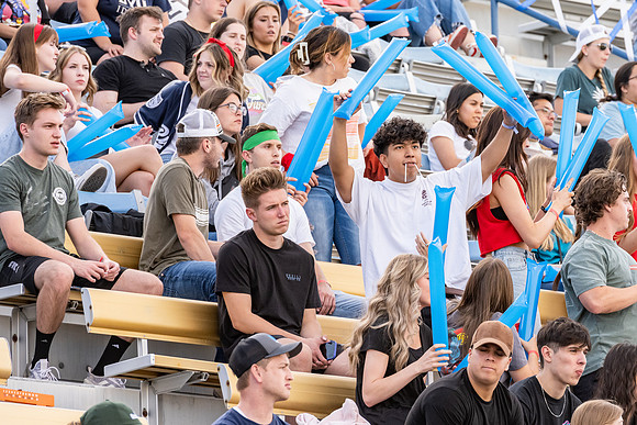 Students gather at the stadium to watch the football championship.