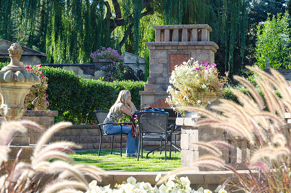 Student talking on the phone between classes in the Thomas E. Ricks Garden