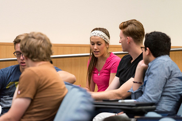 Students talk in groups about the discussion: deviating from the norm and the effect it can have on society.