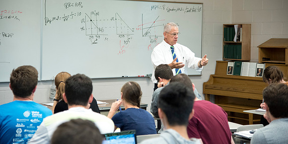 Brother Kerry Webb discusses with his class, the importance of understanding the past and future of the US economy.