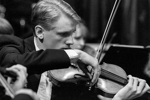 Member of the Orchestra performing a piece
