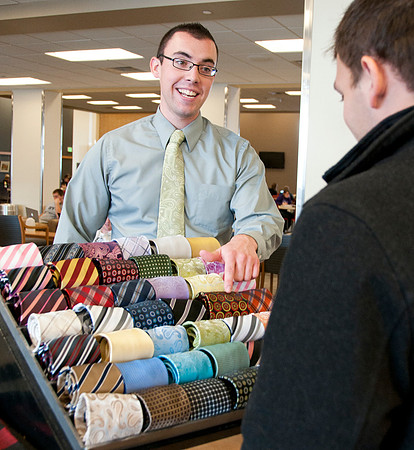 Students from the IBC Business class sell ties and scarfs in the MC Building.