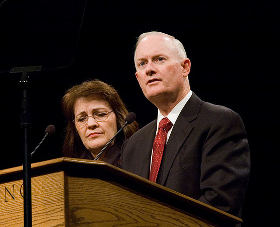 President and Sister Clark speak together during a devotional