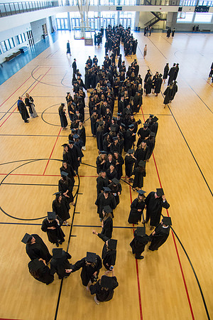 Students line up with their collages preceding the commencement ceremony. Photo by Ryan Chase.