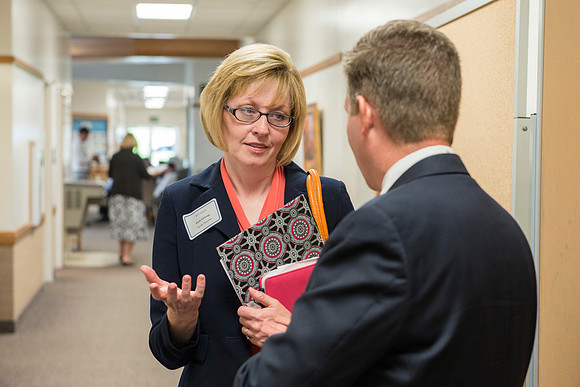 Faculty gather in the Hinckley Building at a Faculty Conference to share and learn from each other at the beginning of the 2013 Fall semester.