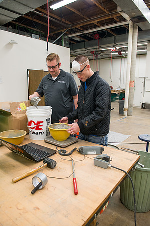 Civil engineering students work with different mixtures of cement to make a light, yet durable, cement that will be the building material for a canoe.