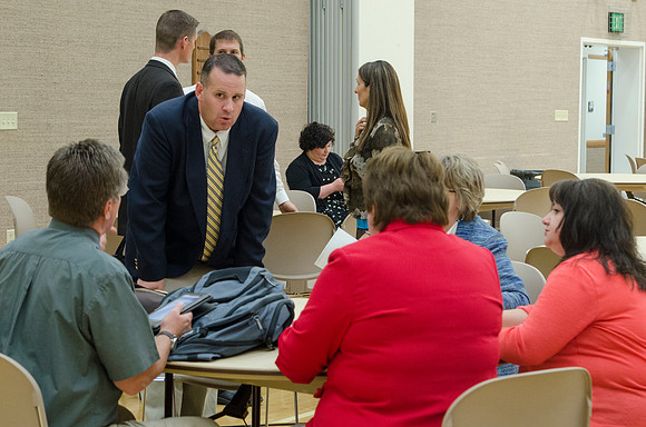 Faculty members talking together at the faculty meeting Fall 2013