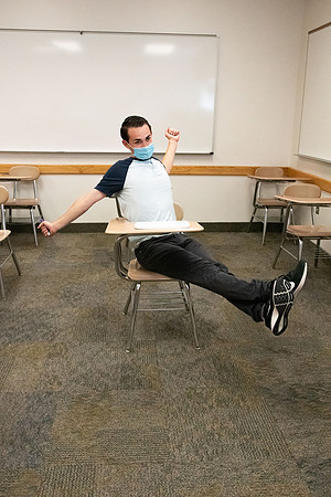 Examples of students staying safe and healthy during the COVID-19 pandemic by social distancing, following pathway arrows, and wearing face masks.