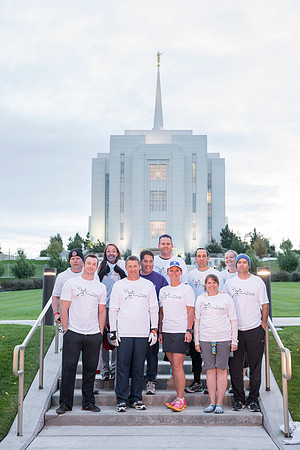 Team members pose by the Rexburg temple before they begin the temple to temple run