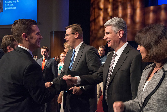 Bishop Gérald Caussé, Presiding Bishop of the Church of Jesus Christ of Latter-Day Saints, shakes hands with students after his devotional address at BYU-Idaho. Photo by Ryan Chase