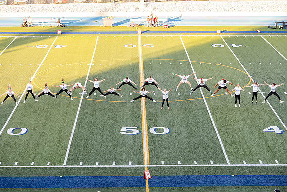 Students gather at the stadium to watch the football championship.