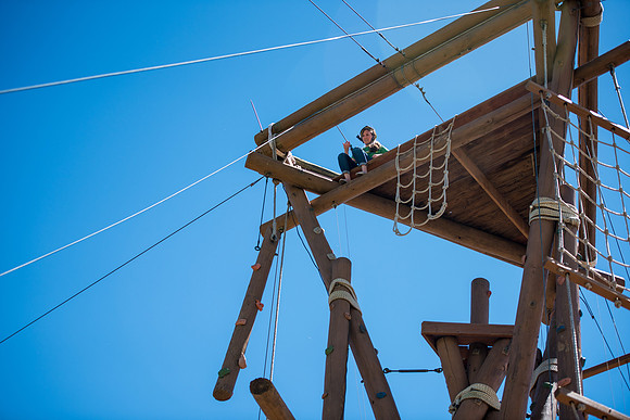 Online Instructors come to BYU-Idaho campus for further learning to enhance teaching skills. Instructors take their turn at the Ropes Course. Online Instructor: Rebecca Dance.