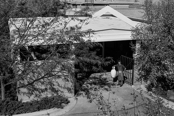 Matthew Geddes stands in front of the Ceramics studio with the new constructed roof.