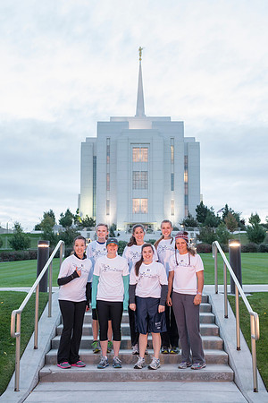 Team members pose by the Rexburg temple before they begin the temple to temple run
