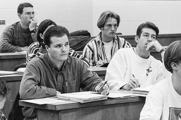 Business teacher, Phillip Packer teaches students in the classroom. December 1995.