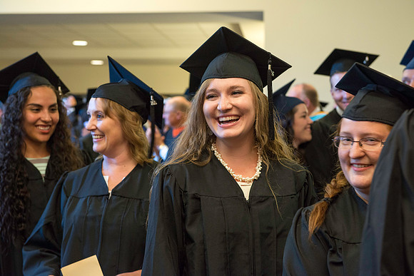 Graduates gather for BYU-Idaho commencement. Graduates march in during the processional.