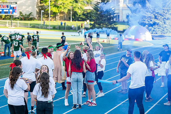 Students gather at the stadium to watch the football championship.