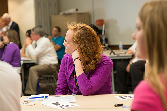Faculty gather in the Hinckley Building at a Faculty Conference to share and learn from each other at the beginning of the 2013 Fall semester.