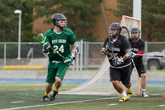 Spartan's Kevin Bosley (24) tests Knight's defender Daniel Calvillo, during Saturday's stormy game at the stadium.
