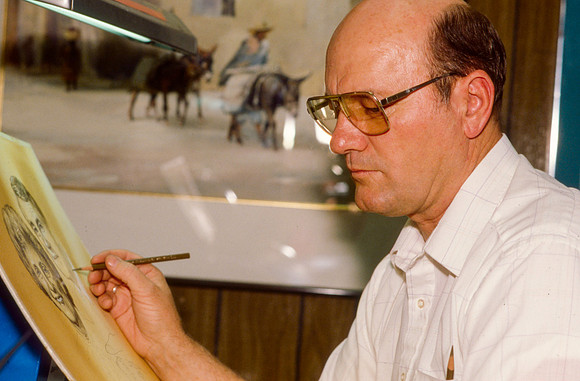 Graphic Artist, Dick Bird, works on an original piece. Illustration for President Joe J. Christensen.