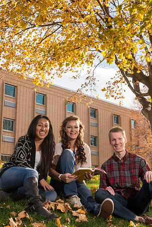 Tanya Flores, Dakodah Terry and Alec Curtis study a textbook on campus grounds during the fall semester for Be Smart.