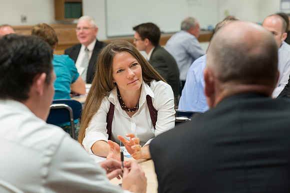 Faculty gather in the Hinckley Building at a Faculty Conference to share and learn from each other at the beginning of the 2013 Fall semester.