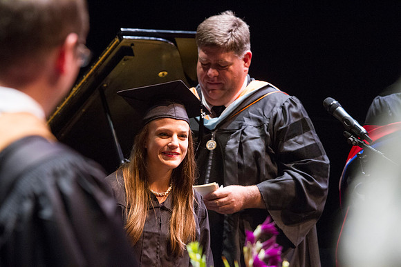 Dean's of the College of Performing and Visual Arts award diplomas to graduates during convocation held in the Snow Building.
