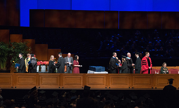 College of Agriculture and Life Sciences Convocation in the Byu-Idaho Center. Elder Wilson and President Clark along with College Dean, John Zenger congratulate the graduates.