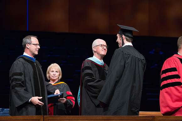 College of Agriculture and Life Sciences Convocation in the Byu-Idaho Center. Elder Wilson and President Clark along with College Dean, John Zenger congratulate the graduates.