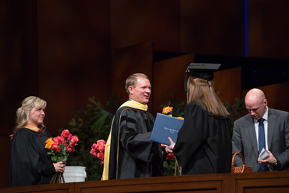 College of Agriculture and Life Sciences Convocation in the Byu-Idaho Center. Elder Wilson and President Clark along with College Dean, John Zenger congratulate the graduates.