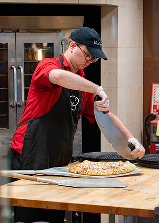 Student employee makes and serves Crepes in the Food Courts, for La Creperie