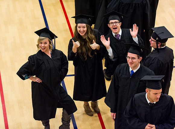 Delaney Earl, left, strikes a pose before Commencement begins.