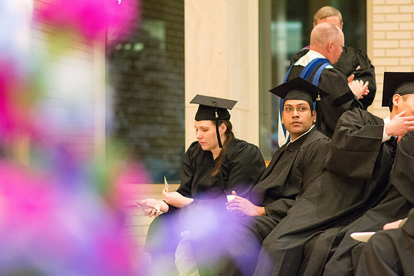 Graduates wait for Convocation to begin in the Taylor Chapel for the College of Physical Sciences.