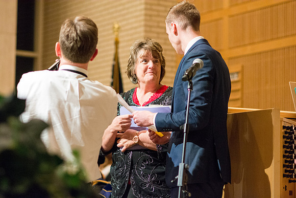 Sister Linda Mitchell helps get everything ready before Convocation is to begin in the Taylor Chapel for the College of Physical Sciences.