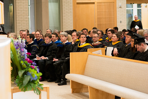 Professors are seated in the Convocation in the Taylor Chapel for the College of Physical Sciences.