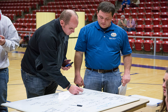 The event organizers finish the brackets.