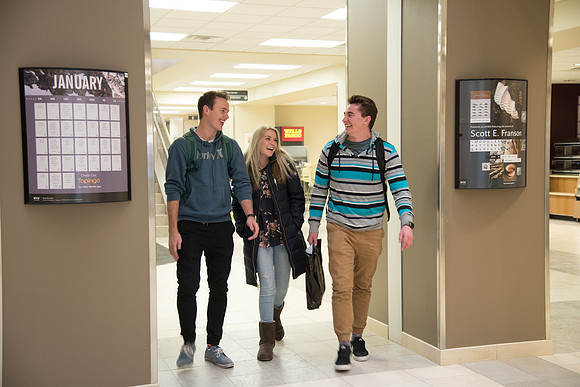 Friends catch up with each other as they walk through the Manwaring Center.