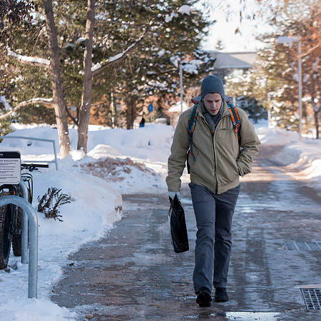 Students return to campus in the frigid cold temperatures.