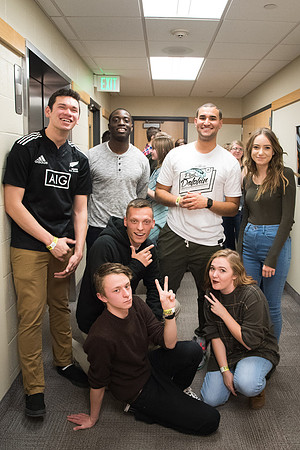 A group of incoming freshmen patiently wait in line for a game of Lazer-Tag.