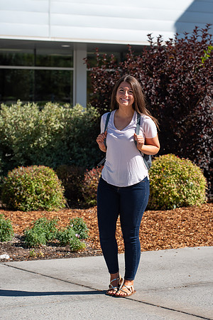 Examples of students staying safe and healthy during the COVID-19 pandemic by social distancing, following pathway arrows, and wearing face masks.