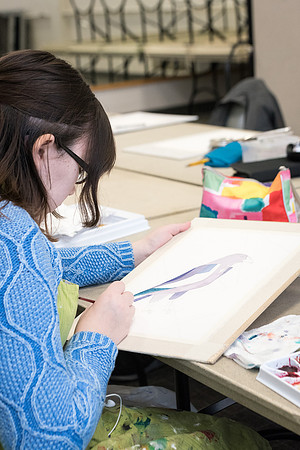 Students work on paintings in Sally Ellis' watercolor class.