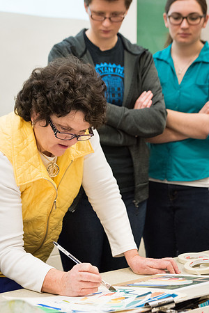 Students work on paintings in Sally Ellis' watercolor class.