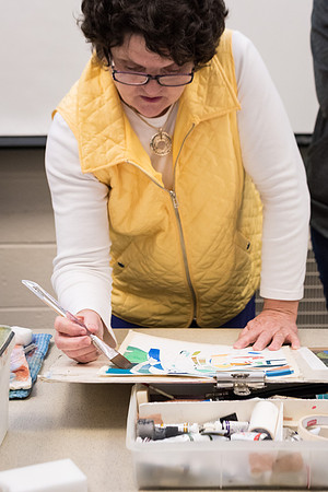 Students work on paintings in Sally Ellis' watercolor class.